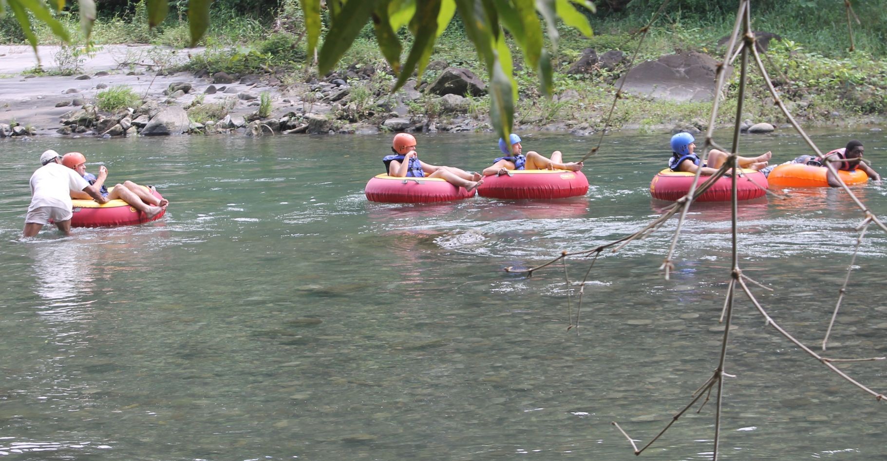 Guests enjoying a guided river tubing experience in Dominica with Antours