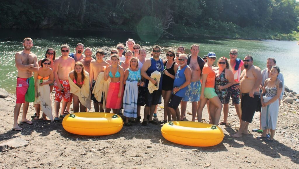 Happy guests celebrating the end of a guided river tubing tour in Dominica