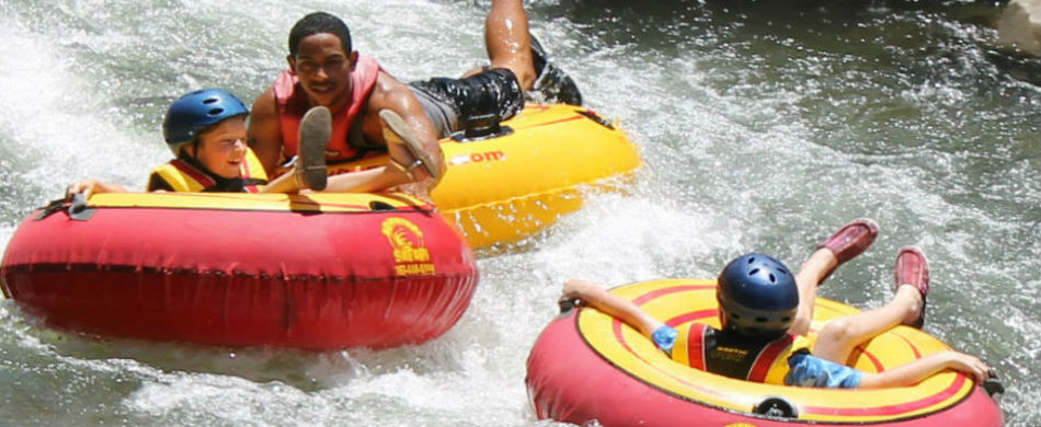 Children enjoying a guided river tubing experience with Antours in Dominica